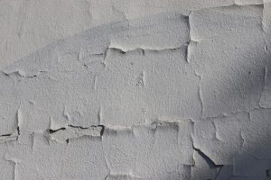 Photo treatment of paint cracks